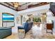 Spacious living room with high ceilings, balcony, comfortable seating, and stylish travertine floors at 21210 77Th E Ave, Bradenton, FL 34202