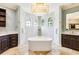 Luxurious bathroom showcasing a large tub, dual vanities, and a bright, modern design at 21210 77Th E Ave, Bradenton, FL 34202