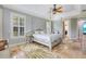 Lovely main bedroom with a sitting area, tray ceiling, and plantation shutters at 21210 77Th E Ave, Bradenton, FL 34202