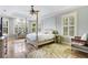 Serene main bedroom featuring a four-poster bed, plantation shutters, and tray ceiling at 21210 77Th E Ave, Bradenton, FL 34202