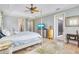 Airy main bedroom featuring neutral colors, a tray ceiling, and tile flooring at 21210 77Th E Ave, Bradenton, FL 34202