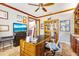 Bright office with a large wooden desk, travertine floors, and plenty of shelving for storage at 21210 77Th E Ave, Bradenton, FL 34202