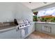 Outdoor kitchen features a built-in grill, granite countertops and convenient sink at 21210 77Th E Ave, Bradenton, FL 34202