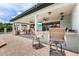 Well-appointed outdoor kitchen includes bar seating, sink, and TV for entertaining at 21210 77Th E Ave, Bradenton, FL 34202