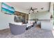 Relaxing covered patio with comfortable seating, TV, and outdoor kitchen area at 21210 77Th E Ave, Bradenton, FL 34202