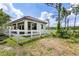 Charming pool house with a white picket fence and ample space for relaxation and entertainment at 21210 77Th E Ave, Bradenton, FL 34202