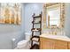 Stylish powder room with a decorative mirror and a unique shelving unit at 21210 77Th E Ave, Bradenton, FL 34202