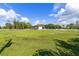 A lush green field surrounds the stables, providing ample space for horses to graze and exercise at 21210 77Th E Ave, Bradenton, FL 34202