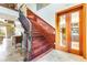 Elegant staircase with wooden steps, dark iron railings, and stylish doors at 21210 77Th E Ave, Bradenton, FL 34202