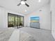 Spacious bedroom with neutral tones, ceiling fan, and balcony overlooking serene outdoor view at 2155 Harbourside Dr # 804, Longboat Key, FL 34228