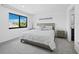 Bright bedroom with a large window, neutral decor, and plush carpeting at 2155 Harbourside Dr # 804, Longboat Key, FL 34228