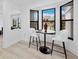 Bright breakfast nook with black table and chairs overlooking scenic outdoor view at 2155 Harbourside Dr # 804, Longboat Key, FL 34228