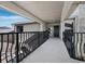 Front porch with dark metal railings leading to a dark-colored front door at 2155 Harbourside Dr # 804, Longboat Key, FL 34228