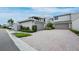 Property exterior with two-car garage, brick driveway, and manicured landscaping at 2155 Harbourside Dr # 804, Longboat Key, FL 34228