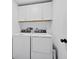 Well-lit laundry room with modern washer and dryer, and overhead storage cabinets at 2155 Harbourside Dr # 804, Longboat Key, FL 34228