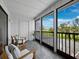 Relaxing screened patio with wooden furniture overlooking a well-maintained green lawn at 2155 Harbourside Dr # 804, Longboat Key, FL 34228