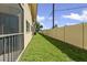 Backyard featuring a well-maintained lawn and a private fence, offering a serene outdoor space at 2415 Bayshore Gardens Pkwy # 2, Bradenton, FL 34207