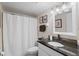 Bathroom featuring a granite-topped vanity, framed mirror, and a shower with a curtain at 2415 Bayshore Gardens Pkwy # 2, Bradenton, FL 34207