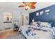 Spacious bedroom features a king-size bed, a blue accent wall, and an en-suite bathroom at 2415 Bayshore Gardens Pkwy # 2, Bradenton, FL 34207