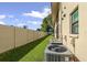 Exterior view of property showcasing lush green lawn and the property's central air conditioning units at 2415 Bayshore Gardens Pkwy # 2, Bradenton, FL 34207