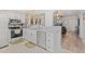 Bright kitchen featuring white cabinets, stainless steel appliances, and an open layout to the living area at 2415 Bayshore Gardens Pkwy # 2, Bradenton, FL 34207