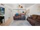 Inviting living room featuring hardwood floors, ceiling fan, modern decor, and kitchen views at 2415 Bayshore Gardens Pkwy # 2, Bradenton, FL 34207