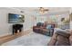 Relaxing living room featuring hardwood floors, ceiling fan, modern decor, and kitchen views at 2415 Bayshore Gardens Pkwy # 2, Bradenton, FL 34207
