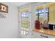 Kitchenette area with outdoor access to the screened patio through a glass paneled door at 2415 Bayshore Gardens Pkwy # 2, Bradenton, FL 34207