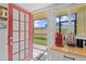 Kitchenette area with outdoor access to the screened patio through a red trimmed glass paneled door at 2415 Bayshore Gardens Pkwy # 2, Bradenton, FL 34207