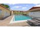 Community pool surrounded by lounge chairs, perfect for relaxing and enjoying sunny days at 2415 Bayshore Gardens Pkwy # 2, Bradenton, FL 34207