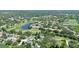 Scenic aerial view of a home nestled within a lush, green community with a golf course and serene lakes at 2761 Feiffer Cir, Sarasota, FL 34235