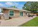 Spacious backyard features a stone patio with outdoor furniture and grill, great for entertaining at 2761 Feiffer Cir, Sarasota, FL 34235