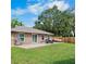 A spacious backyard featuring a patio, green grass, and a stainless steel grill perfect for outdoor entertaining at 2761 Feiffer Cir, Sarasota, FL 34235