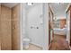 Compact bathroom with a tiled shower and view of the carpeted main bedroom at 2761 Feiffer Cir, Sarasota, FL 34235