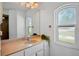 Well lit bathroom featuring a large mirror, a sink with granite countertops, and a window letting in lots of natural light at 2761 Feiffer Cir, Sarasota, FL 34235
