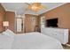 Comfortable bedroom with brown walls, white furnishings, and a tropical ceiling fan at 2761 Feiffer Cir, Sarasota, FL 34235