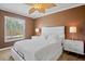 Bedroom featuring neutral walls, white furnishings, and a tropical ceiling fan at 2761 Feiffer Cir, Sarasota, FL 34235