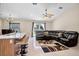 Open-concept living area with tile floors, ceiling fan, and kitchen bar at 2761 Feiffer Cir, Sarasota, FL 34235