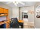The home office includes a ceiling fan and a large desk, with a view to the dining room and living room at 2761 Feiffer Cir, Sarasota, FL 34235