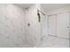Bathroom shower featuring marble style tile and new fixtures at 2919 Shannon Drive, Punta Gorda, FL 33950