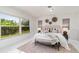 Bright bedroom features modern decor, a decorative headboard, and a large window with a lush view at 2919 Shannon Drive, Punta Gorda, FL 33950