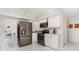 Modern kitchen with stainless steel appliances, white cabinets, marble floors, and sleek finishes for culinary enthusiasts at 2919 Shannon Drive, Punta Gorda, FL 33950