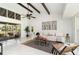 Spacious living room with high ceilings, wood beams, marble floors, leading to a bright, screened-in lanai at 2919 Shannon Drive, Punta Gorda, FL 33950