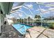 Sparkling blue pool with a screened enclosure, offering waterfront views and a relaxing outdoor space at 2919 Shannon Drive, Punta Gorda, FL 33950