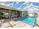 Enclosed pool area with brick pavers, screened enclosure, and easy access to the covered patio at 2919 Shannon Drive, Punta Gorda, FL 33950