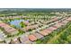 Stunning aerial view of a residential community surrounding a lake with lush greenery and well-maintained homes at 2920 Oriole Dr, Sarasota, FL 34243