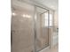 This bathroom features a walk-in shower, a tub, and decorative tile at 2920 Oriole Dr, Sarasota, FL 34243
