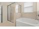 Bathroom with a separate glass-enclosed shower and a soaking tub at 2920 Oriole Dr, Sarasota, FL 34243
