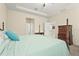 This bedroom features neutral-colored walls, a ceiling fan, and a large four-poster bed at 2920 Oriole Dr, Sarasota, FL 34243