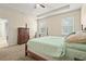 This is a carpeted bedroom with a four-poster bed, light-colored walls, and two windows at 2920 Oriole Dr, Sarasota, FL 34243